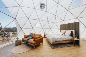 Bed and couch inside the Hideaway Domes accommodation