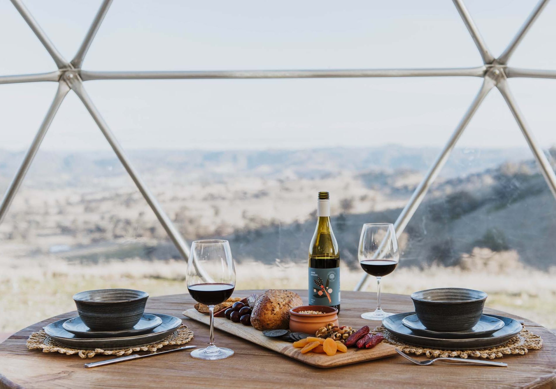 Dinning set with wine and cheese platter at Hideaway Domes